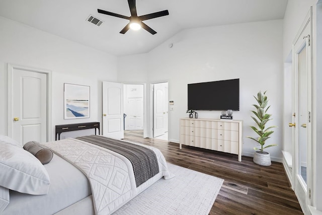 bedroom with ceiling fan, vaulted ceiling, and dark hardwood / wood-style floors