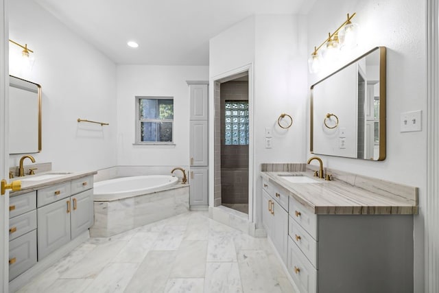 bathroom featuring vanity and shower with separate bathtub