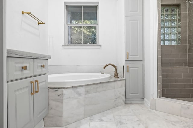 bathroom featuring shower with separate bathtub