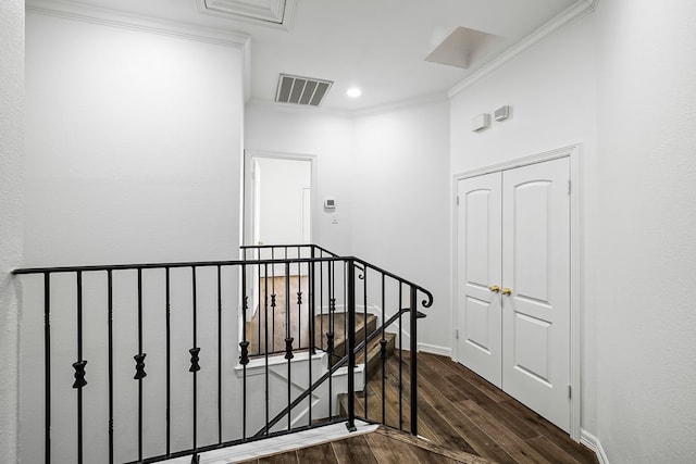 staircase with crown molding and hardwood / wood-style floors