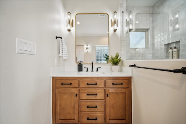 bathroom featuring walk in shower, vanity, and ornamental molding