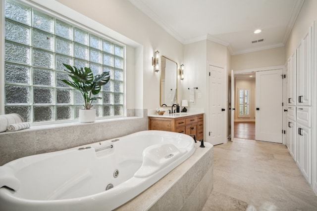 bathroom featuring a relaxing tiled tub, vanity, and ornamental molding