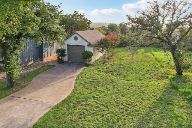 view of front of home with a front lawn, an outbuilding, and a garage