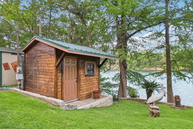 view of outbuilding featuring a yard and a water view