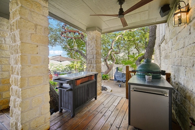 wooden terrace featuring ceiling fan