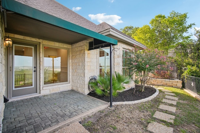 entrance to property featuring a patio area