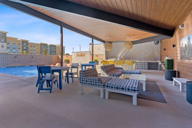 view of patio / terrace with pool water feature and an outdoor living space