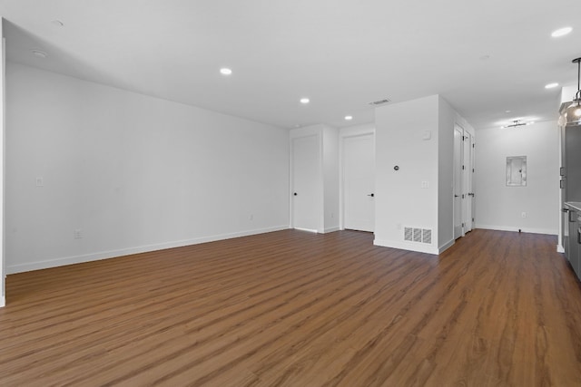 unfurnished room featuring hardwood / wood-style floors and electric panel