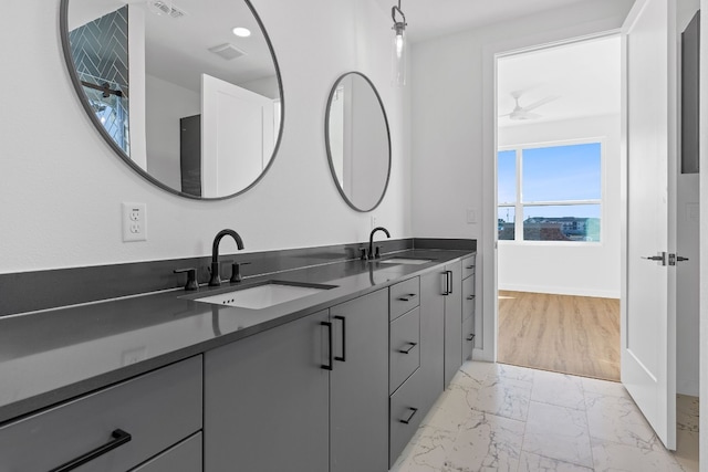 bathroom with tile patterned floors, double sink vanity, and ceiling fan