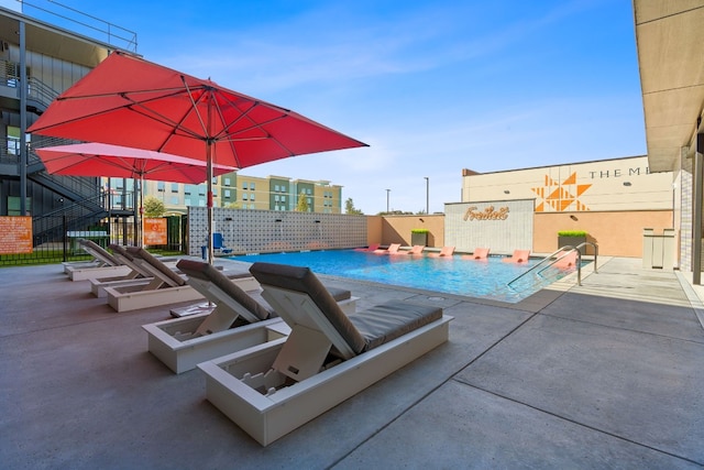 view of swimming pool with a patio area