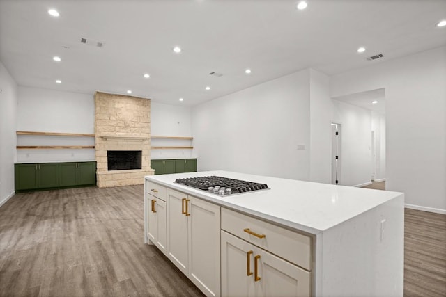 14409 Bois D Arc Ln, Manor, TX 78653 - kitchen with recessed lighting, visible vents, stainless steel gas stovetop, and wood finished floors