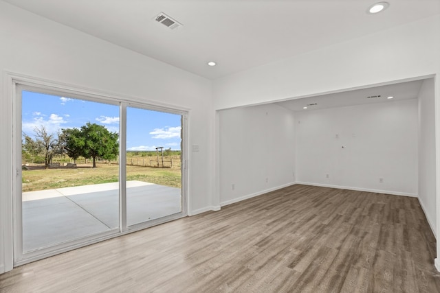 unfurnished room with light hardwood / wood-style flooring