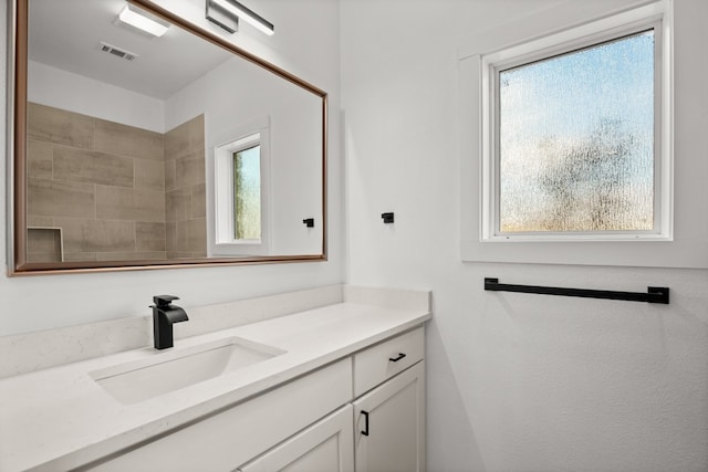 bathroom with vanity and a healthy amount of sunlight