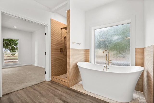 14409 Bois D Arc Ln, Manor, TX 78653 - bathroom with a shower stall, a freestanding tub, tile walls, and wood finished floors