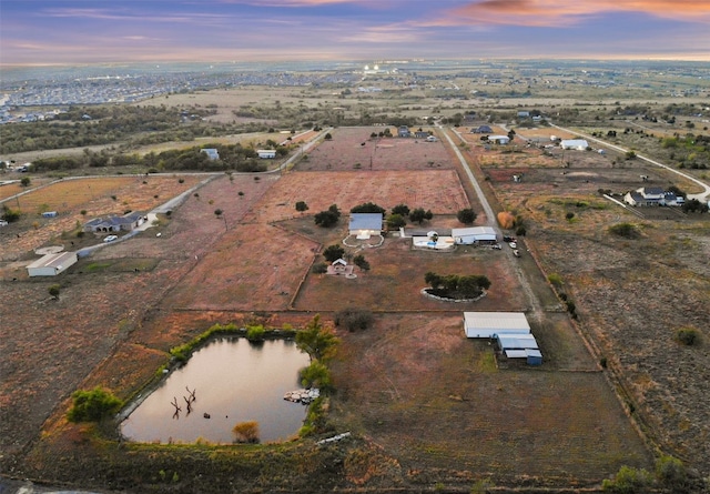 aerial view at dusk with a water view