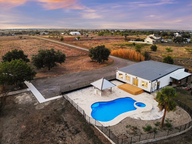 14409 Bois D Arc Ln, Manor, TX 78653 - view of swimming pool with a pool with connected hot tub, a patio, a fenced backyard, a gazebo, and a rural view
