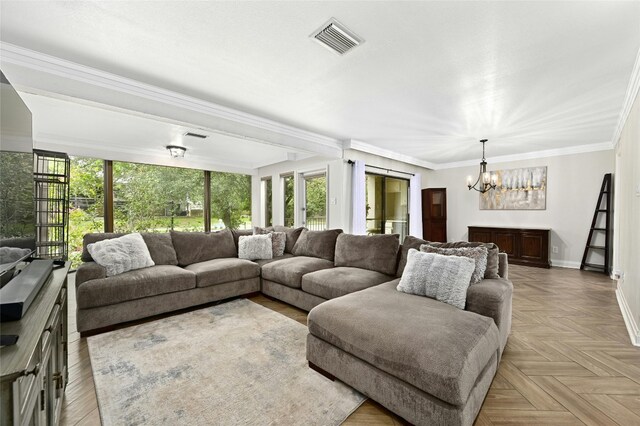 living room featuring an inviting chandelier, ornamental molding, and light parquet flooring