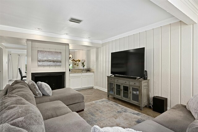 living room with parquet flooring and ornamental molding