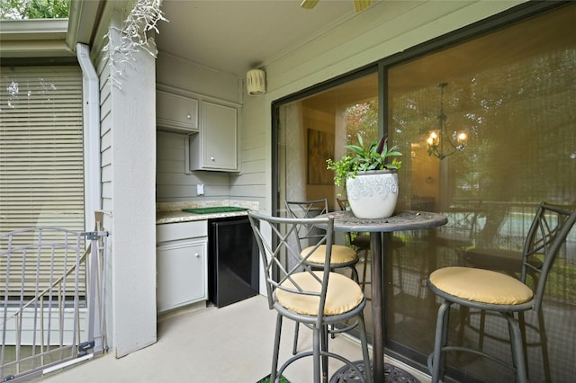 kitchen with fridge and gray cabinetry