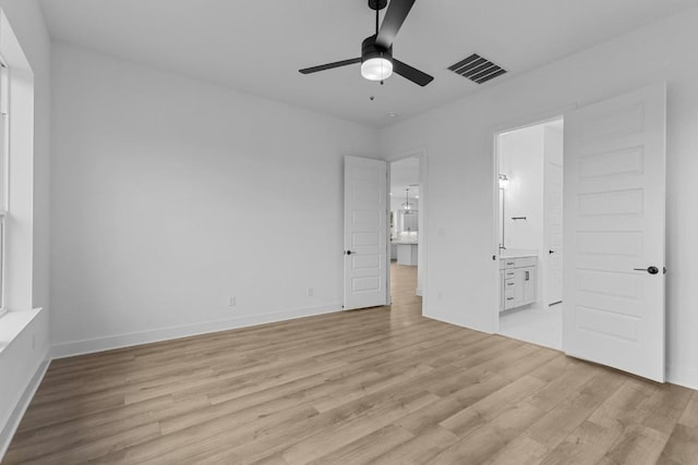 unfurnished bedroom featuring ensuite bath, ceiling fan, and light hardwood / wood-style floors