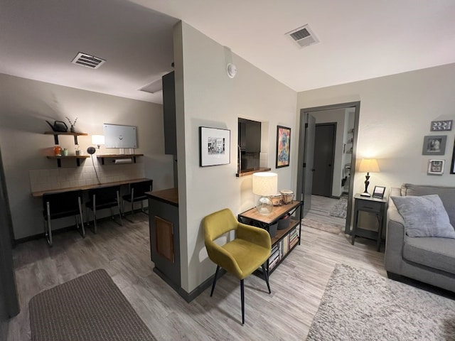 interior space featuring lofted ceiling and hardwood / wood-style floors