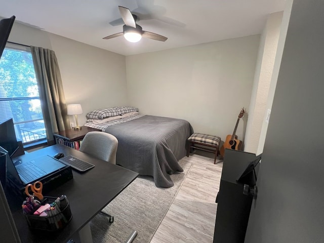 bedroom featuring light hardwood / wood-style floors, multiple windows, and ceiling fan