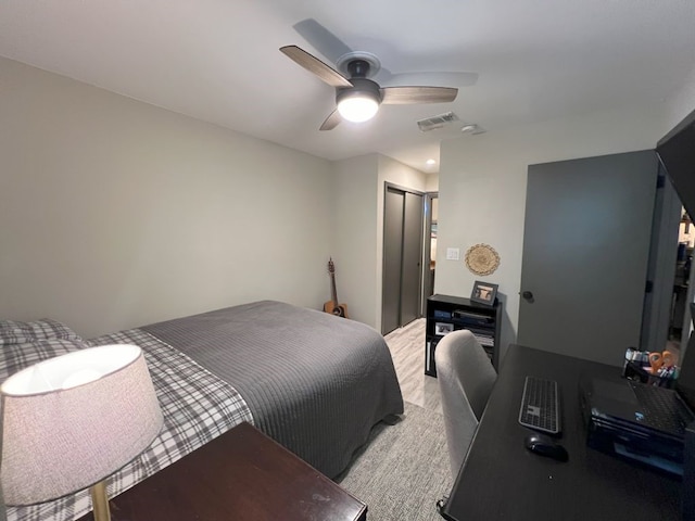 carpeted bedroom featuring a closet and ceiling fan