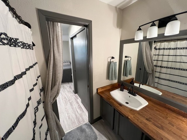 bathroom featuring vanity and wood-type flooring