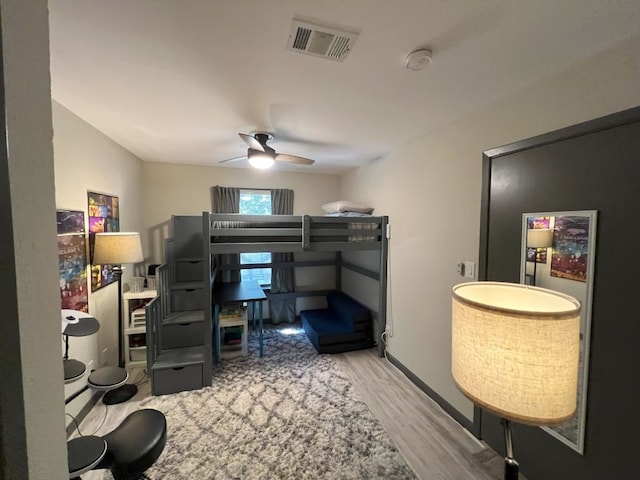 home office with light wood-type flooring and ceiling fan