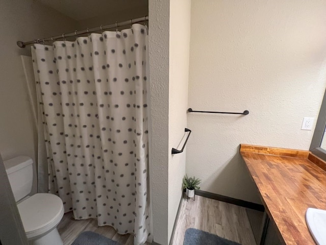 bathroom featuring hardwood / wood-style floors, toilet, and vanity