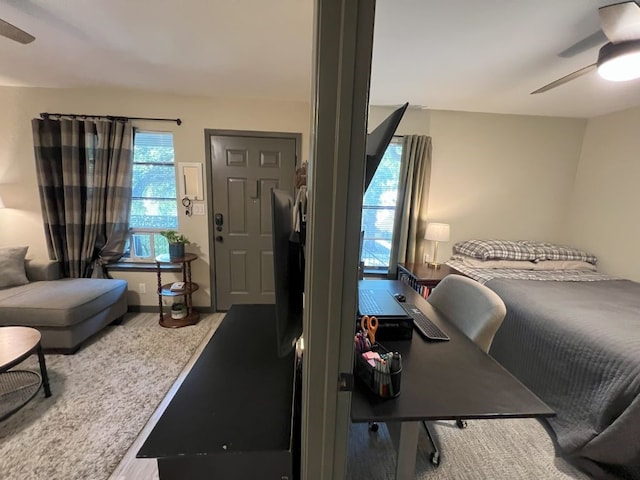 bedroom featuring multiple windows and ceiling fan