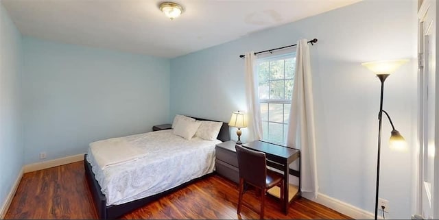 bedroom with dark wood-type flooring