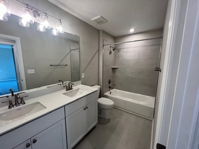 full bathroom featuring vanity, toilet, and tiled shower / bath combo