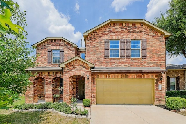 view of front of house with brick siding, driveway, and an attached garage