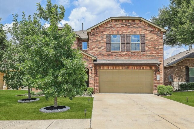 view of front of property with a garage and a front lawn