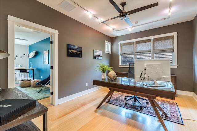 office space featuring hardwood / wood-style flooring, track lighting, and ceiling fan