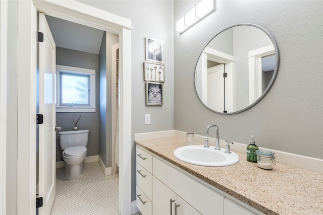 bathroom featuring vanity, toilet, and tile patterned flooring