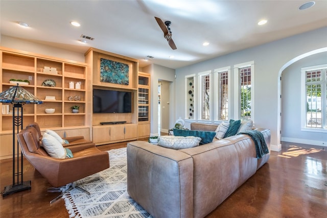 living room featuring ceiling fan and concrete floors