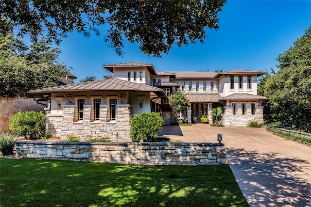 prairie-style home featuring a front yard