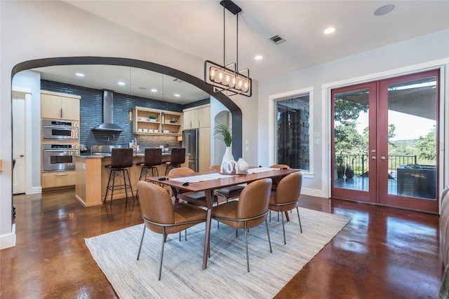 dining room with a wood stove and french doors