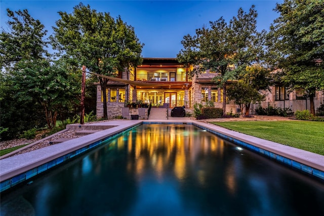 view of pool with a yard