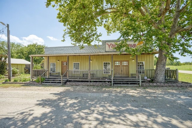 128 Gonzales St, Paige, TX 78659 - view of front of property featuring a porch and board and batten siding