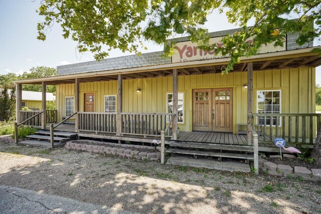 128 Gonzales St, Paige, TX 78659 - view of front facade featuring a porch and board and batten siding