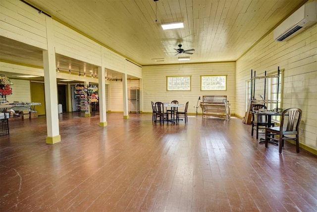 128 Gonzales St, Paige, TX 78659 - interior space featuring hardwood / wood-style floors, a ceiling fan, an AC wall unit, and wooden ceiling