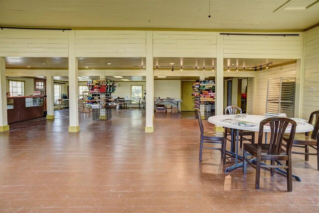 128 Gonzales St, Paige, TX 78659 - dining area with wood walls and wood finished floors