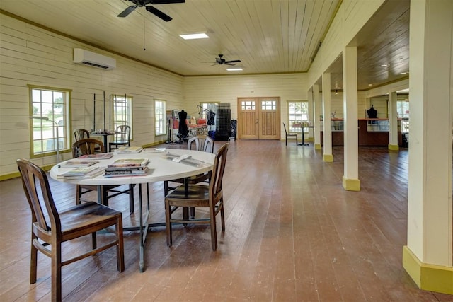128 Gonzales St, Paige, TX 78659 - dining room with wood ceiling, a wall mounted AC, a ceiling fan, hardwood / wood-style flooring, and healthy amount of natural light