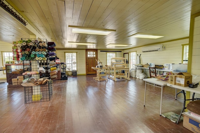 misc room with a skylight, wood ceiling, wood walls, hardwood / wood-style flooring, and a wall mounted air conditioner