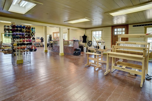 gym featuring hardwood / wood-style flooring, wooden walls, and wooden ceiling