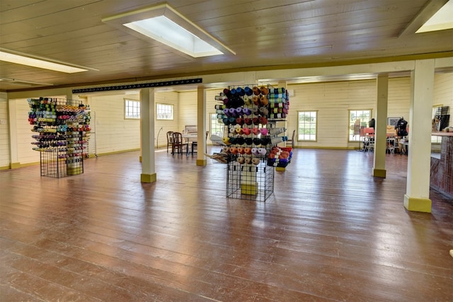 exercise room with wood walls, hardwood / wood-style floors, and wooden ceiling