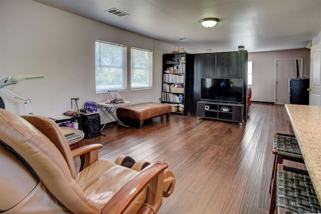 128 Gonzales St, Paige, TX 78659 - living area with visible vents, a healthy amount of sunlight, and wood finished floors